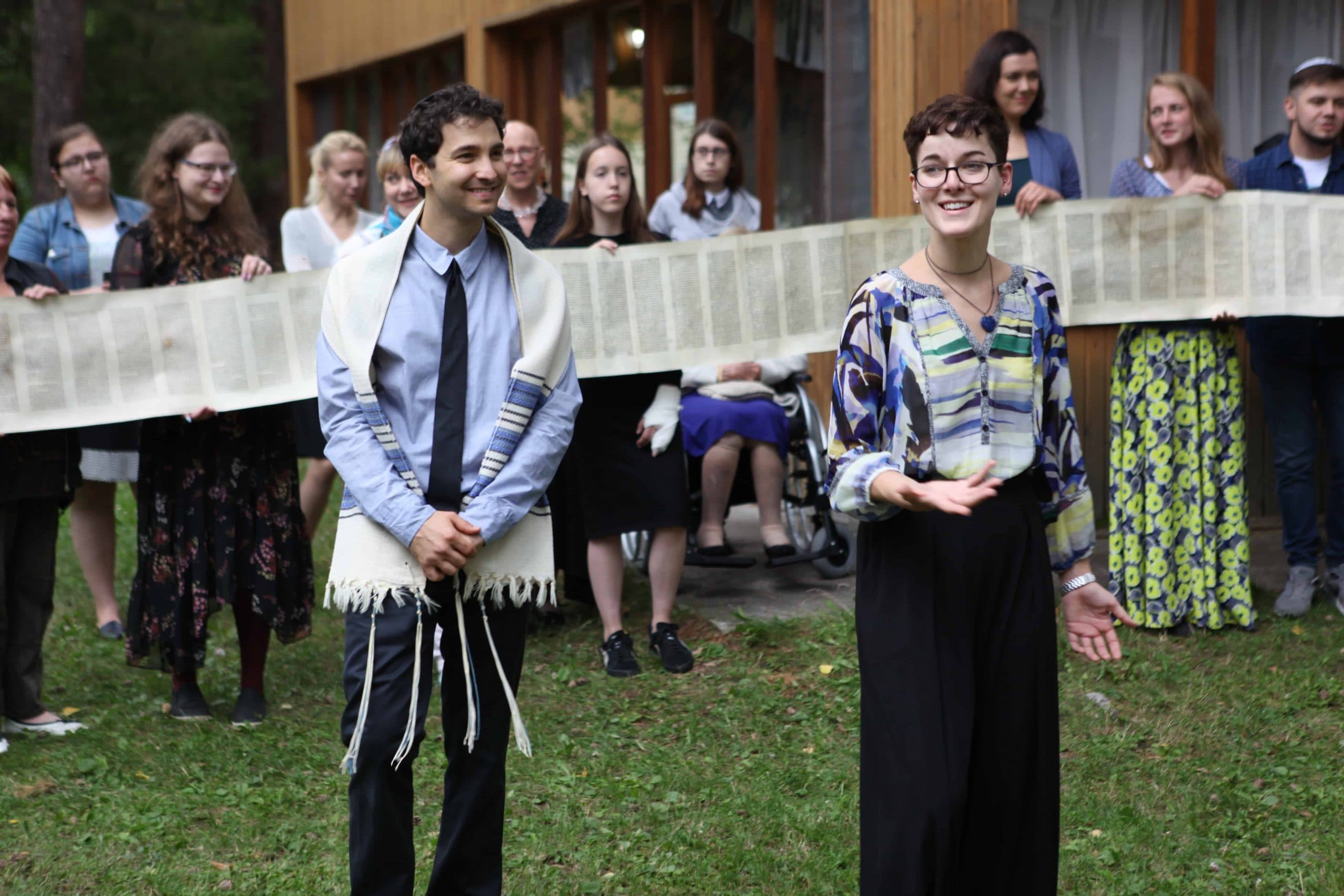 Rabbinical student Rachel Simmons (center right) leads Siberian Jewish who surround her with a torah scroll.