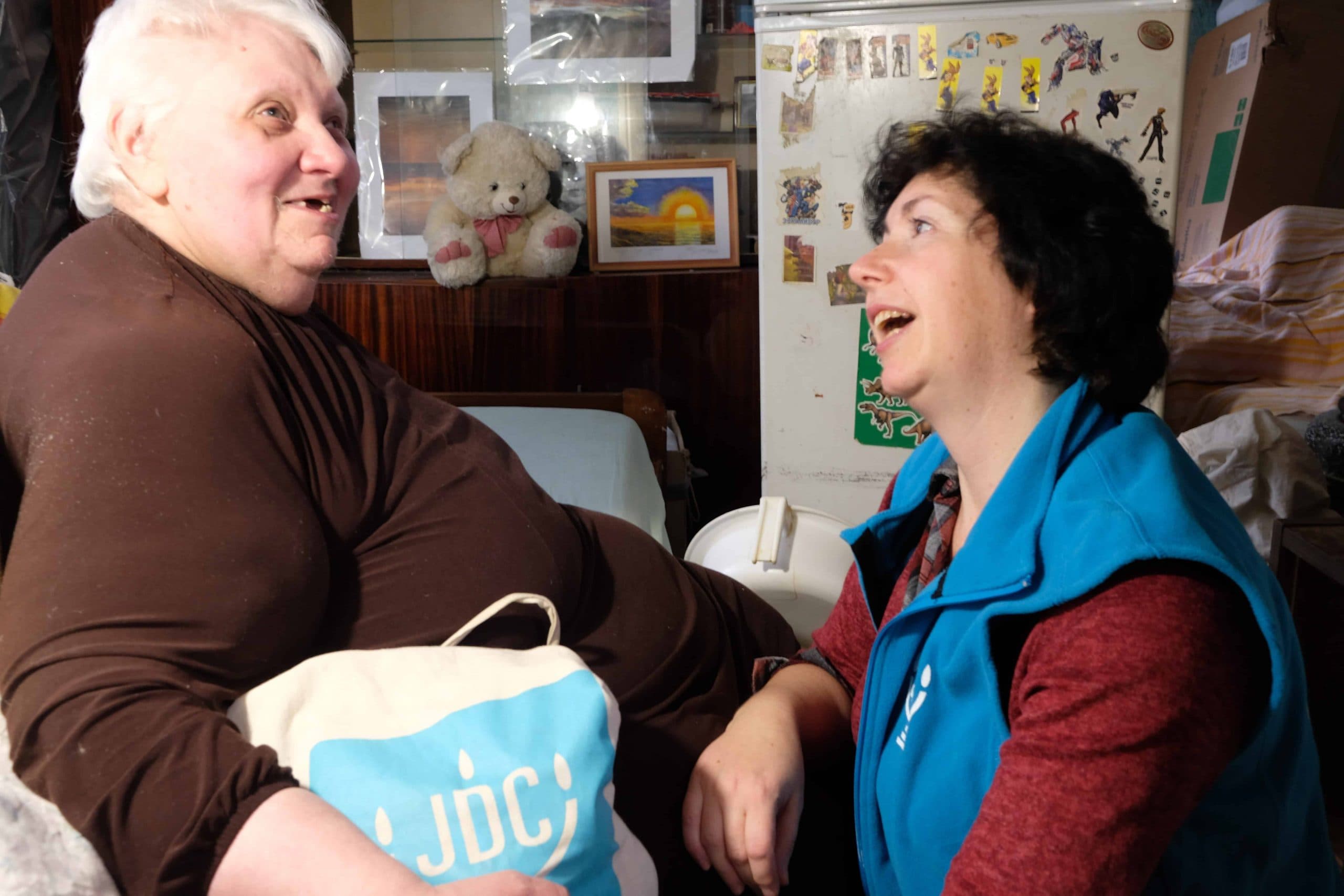 Liudmila Starikovich laughs with her JDC homecare worker.