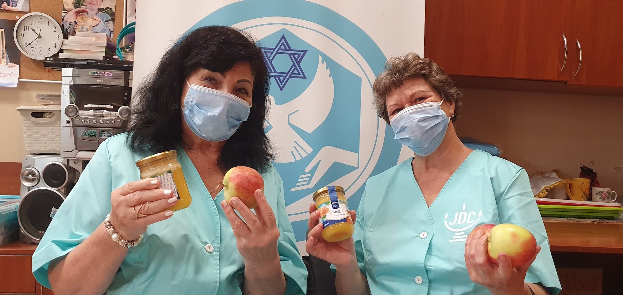 Two volunteers at the JDC-supported Hesed Shaarey Tzion in Odessa, Ukraine, prepare Rosh Hashanah food sets for elderly clients.
