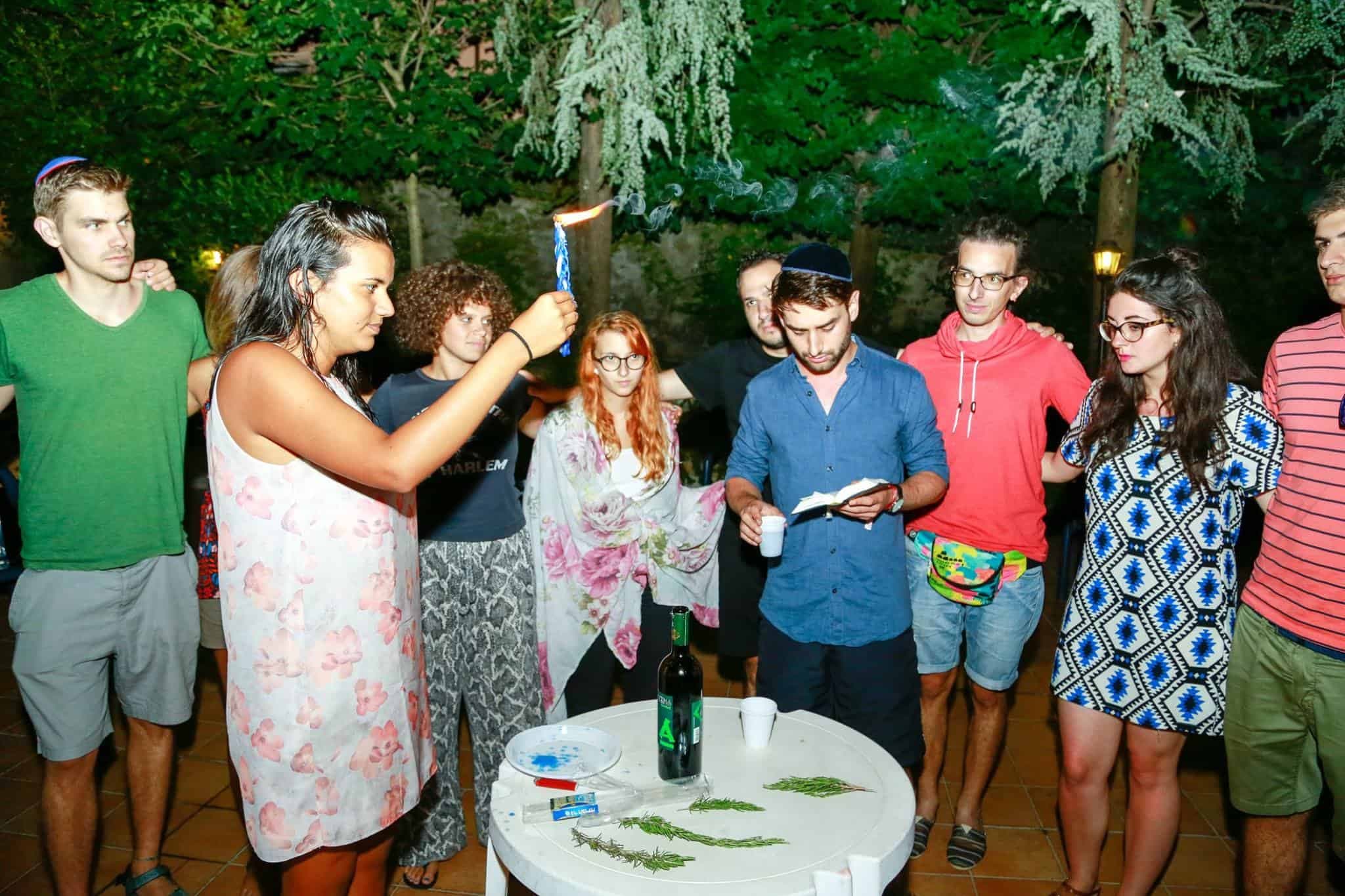 Benjamin Fischer (center) helps lead a havdalah service with other young German Jews.