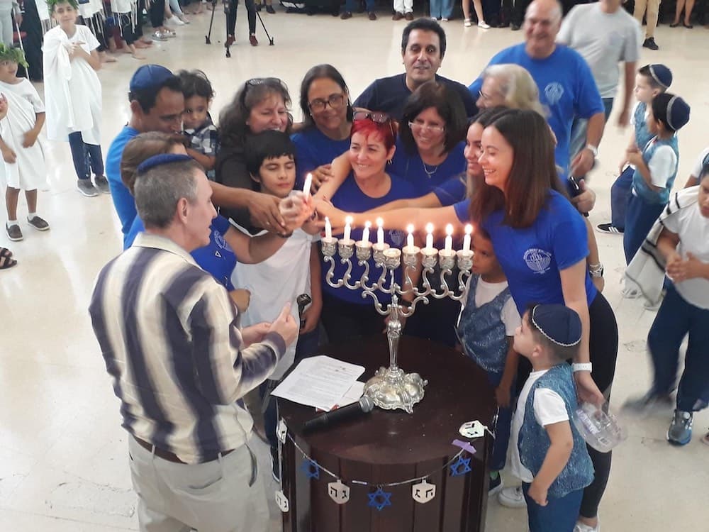 People lighting Chanukah candles